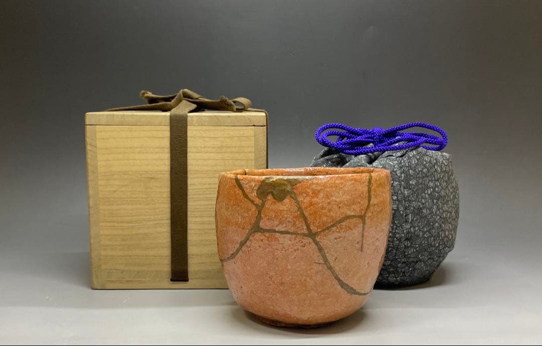 Kintsugi-repaired Raku tea bowl with tomobako and silk shifuku