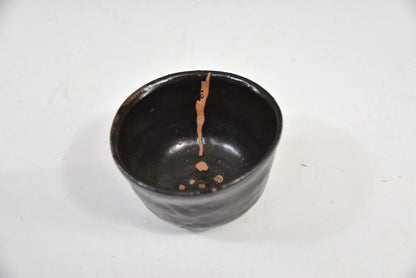 Kuro-yu Yakimuke Chawan — Black Glaze Resist Matcha Bowl with Grass Motif, Tomobako